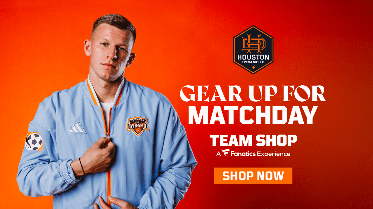 Houston Dynamo player wearing a blue club jacket against an orange background